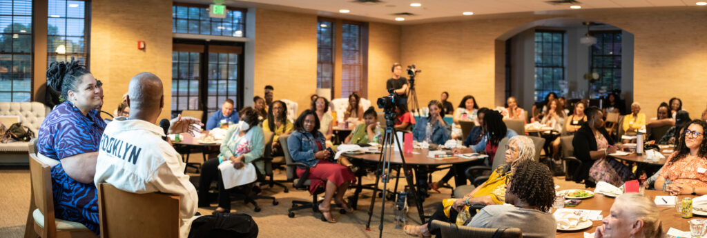 A photo of panelists and the crowd at Writing to Transform Trauma